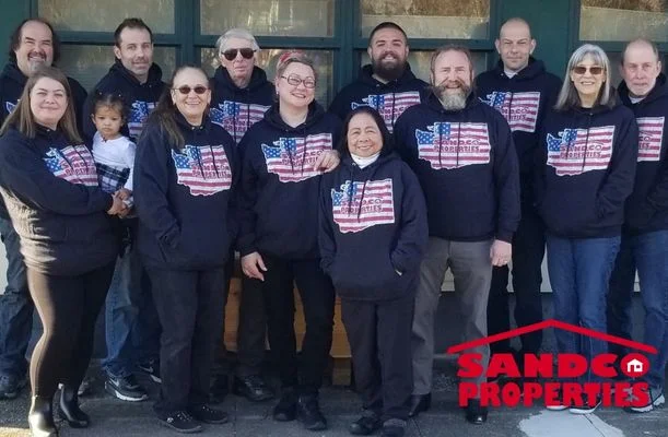 Group of People wearing navy blue hoodies with an american flag